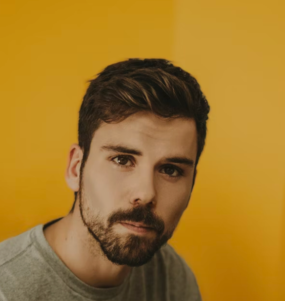 Young man yellow background portrait